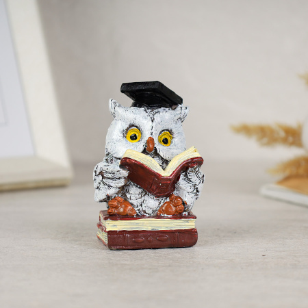 716063!Читает книжку и держит двумя крыльями на двух книжках стоит.jpg